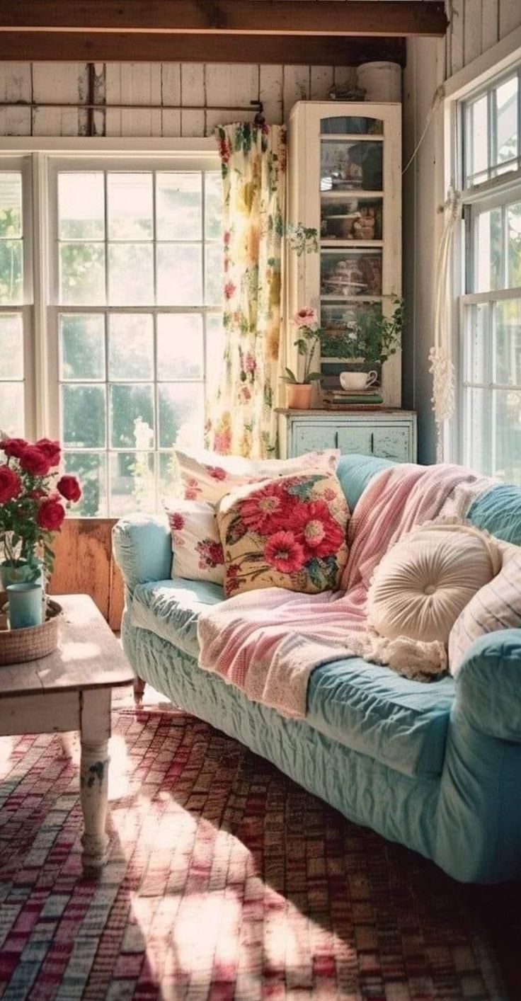 a living room filled with lots of furniture and flowers in vases on the windowsill