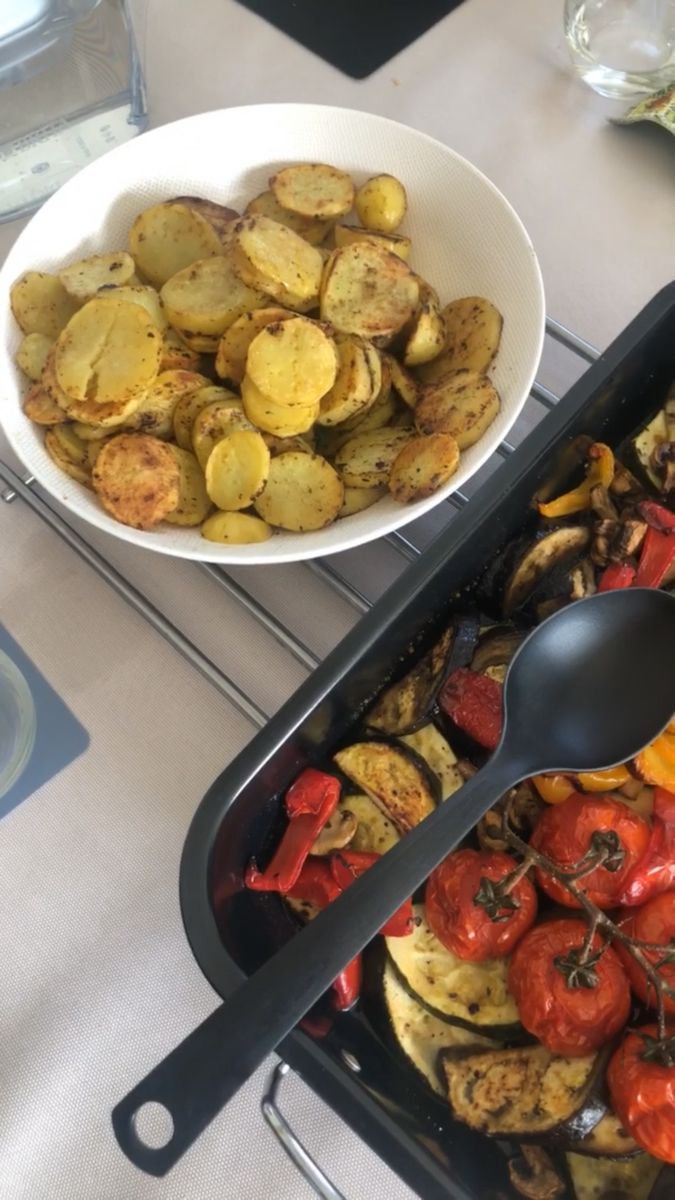 two pans filled with different types of food next to each other on a table