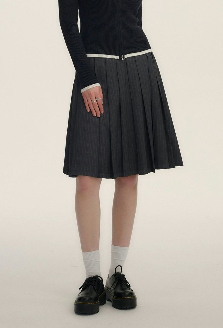 Step into chic sophistication with our Pinstripe Pleated Short-Midi Skirt, a versatile piece tailored to add a touch of moody elegance to your wardrobe.

Crafted with a blend of 70% polyester fiber, 28% viscose, and 2% spandex, this skirt ensures comfort without compromising on style. The classic pinstripe pattern exudes professionalism, while the pleated design adds a playful twist. It's finished with a discreet embroidered logo that subtly elevates the overall aesthetic.

Perfect for transitio Relaxed Skirt With Striped Hem, Chic Striped Lined Skirt Bottoms, Chic Relaxed Skirt With Striped Hem, Chic Skirt With Striped Hem And Relaxed Fit, Chic Spring Skirt With Striped Hem, Elegant Striped Relaxed Skirt, Pleated Striped Skirt For Work, Striped Pleated Skirt For Work, Chic Vertical Stripes Skirt For Spring