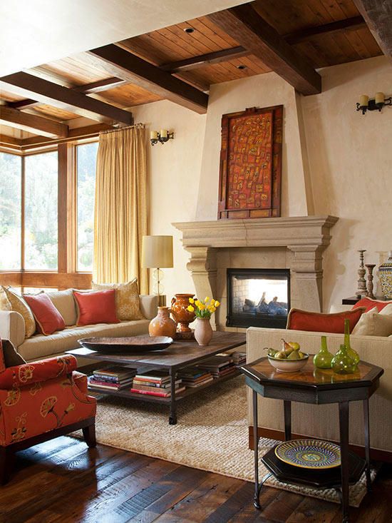 a living room filled with furniture and a fire place in the middle of a room