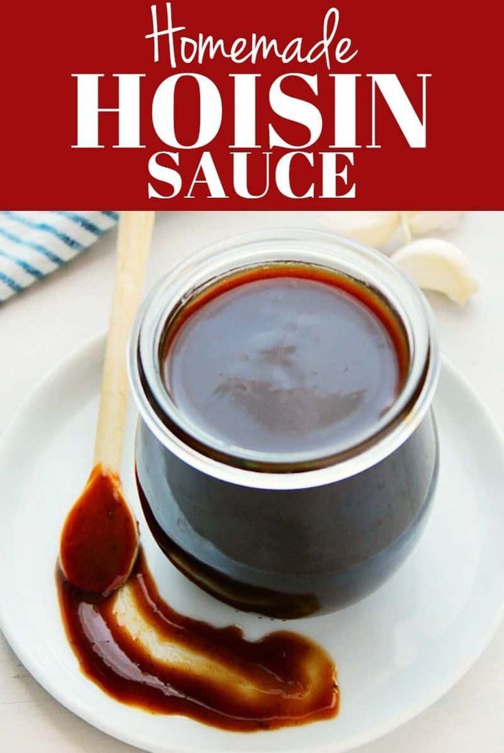 homemade hoisin sauce on a white plate with a wooden spoon