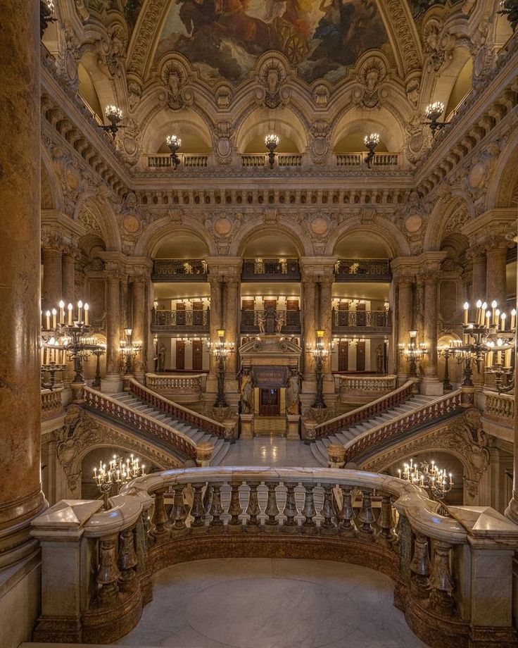 an ornate building with many stairs and chandeliers