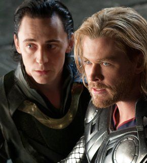 two men dressed as thor and loki in avengers the dark knight saga, one is holding his arm around the other