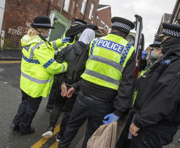 police officers are standing in the street with their hands on each other's backs