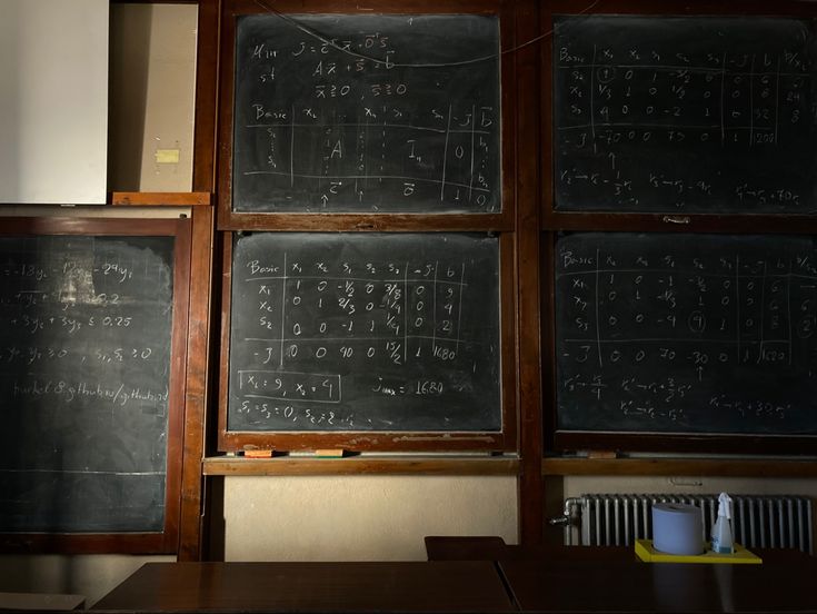 two blackboards with numbers written on them