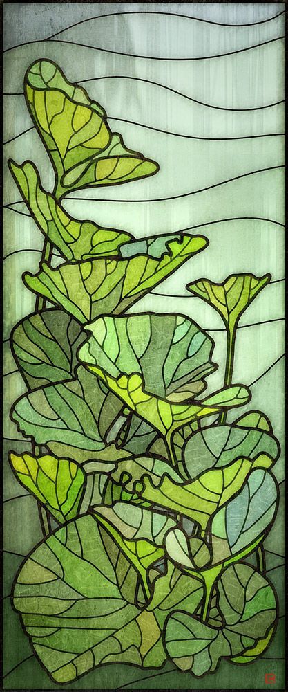 a stained glass window with green leaves on it