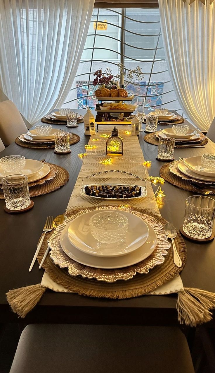 the table is set with plates, silverware and place settings for two people to sit at