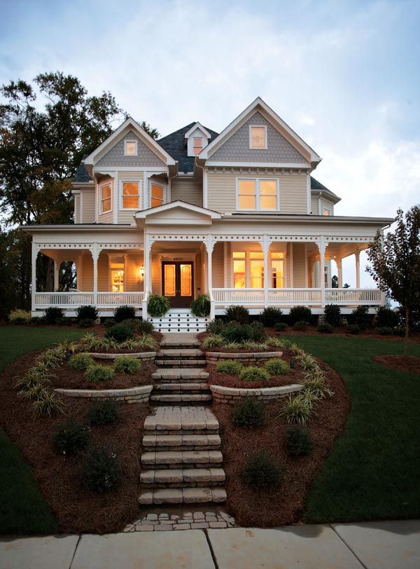 a large white house sitting on top of a lush green field