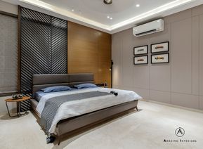 a bedroom with a large bed in the middle of it and pictures on the wall