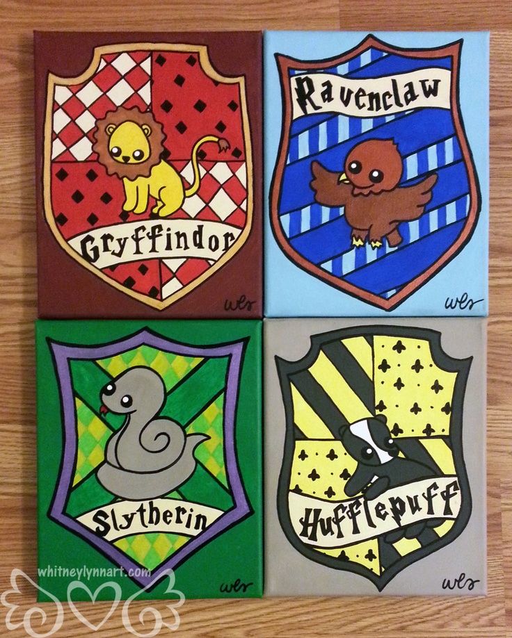 four harry potter crest magnets on a wooden table with the words ravenclaw, gryffindor, slytherin and hogwart