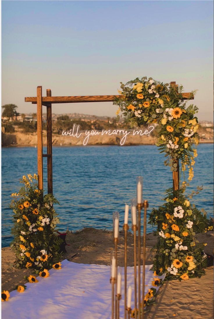 an outdoor ceremony setup with flowers and candles