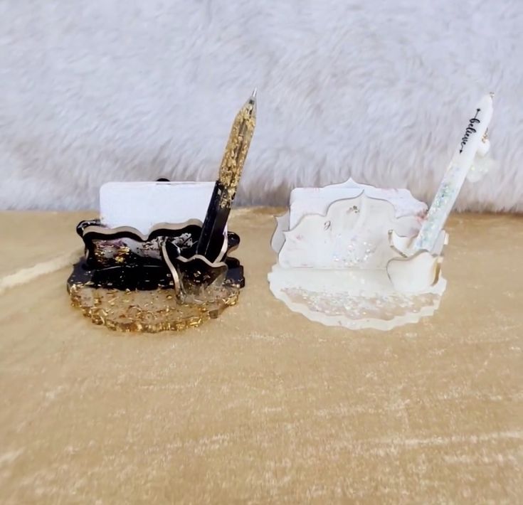 a pen and pencil holder sitting on top of a table next to a white furnishing