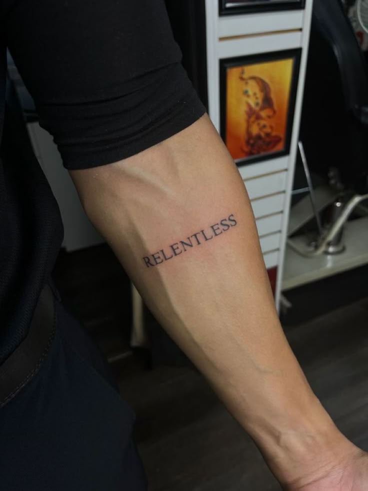 a man with a tattoo on his arm that says,'reentless '