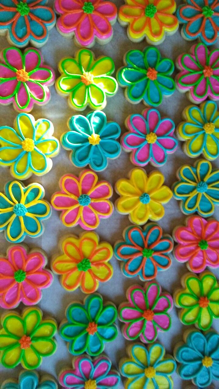 colorful decorated cookies are arranged in the shape of flowers