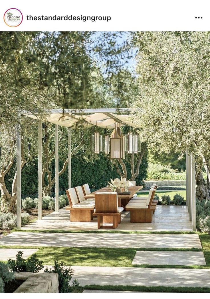 an outdoor dining area in the middle of a garden