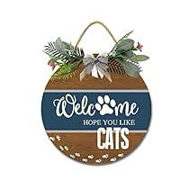 a wooden sign that says welcome hope you like cats with a cat's paw on it