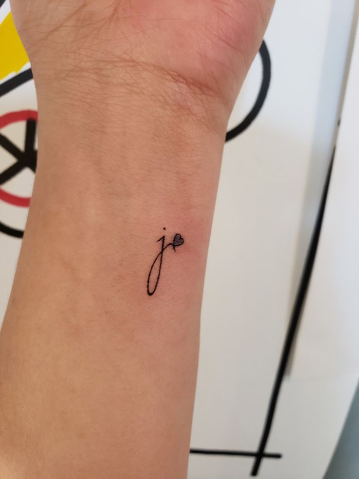 a person with a small tattoo on their wrist