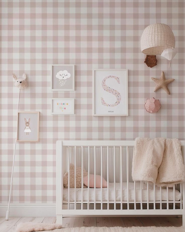 a baby's room with pink and white checkered wallpaper