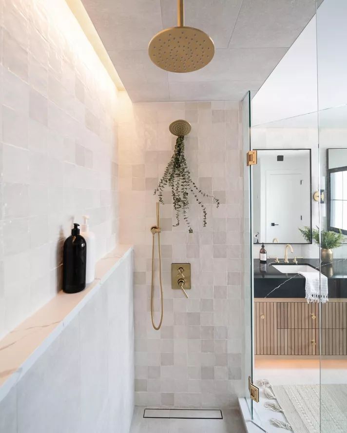 a bathroom with a walk in shower next to a bathtub and toilet paper dispenser