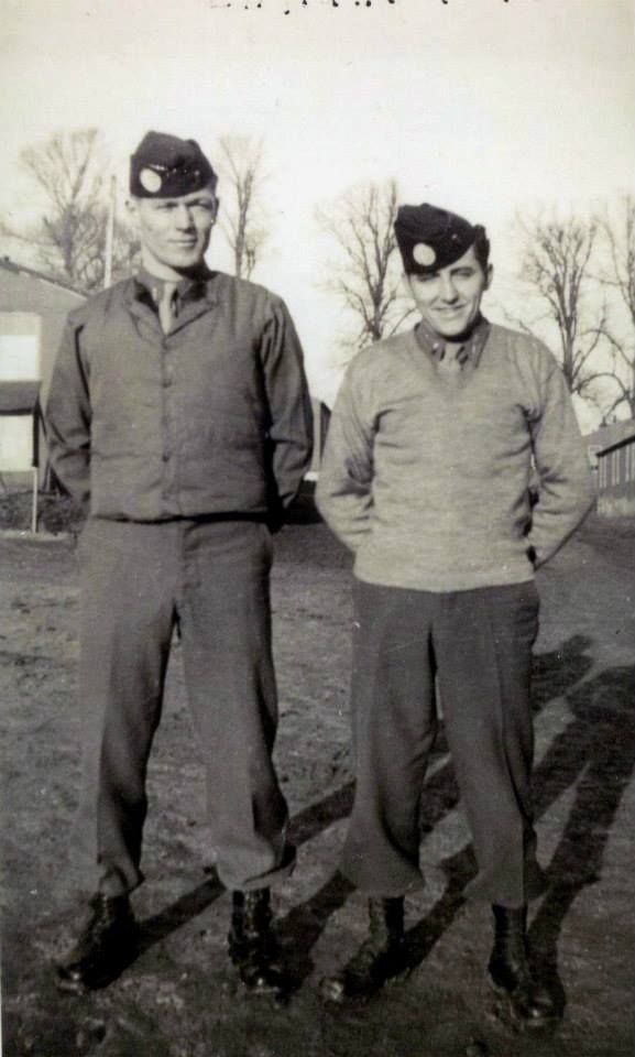 two men standing next to each other on a field