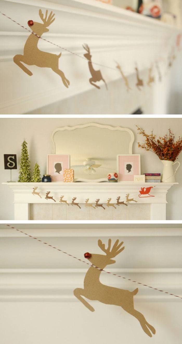 the fireplace mantel is decorated with christmas decorations and deers hanging from it's mantle