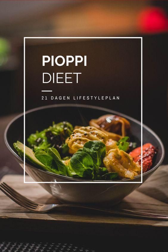 a bowl filled with salad on top of a wooden table