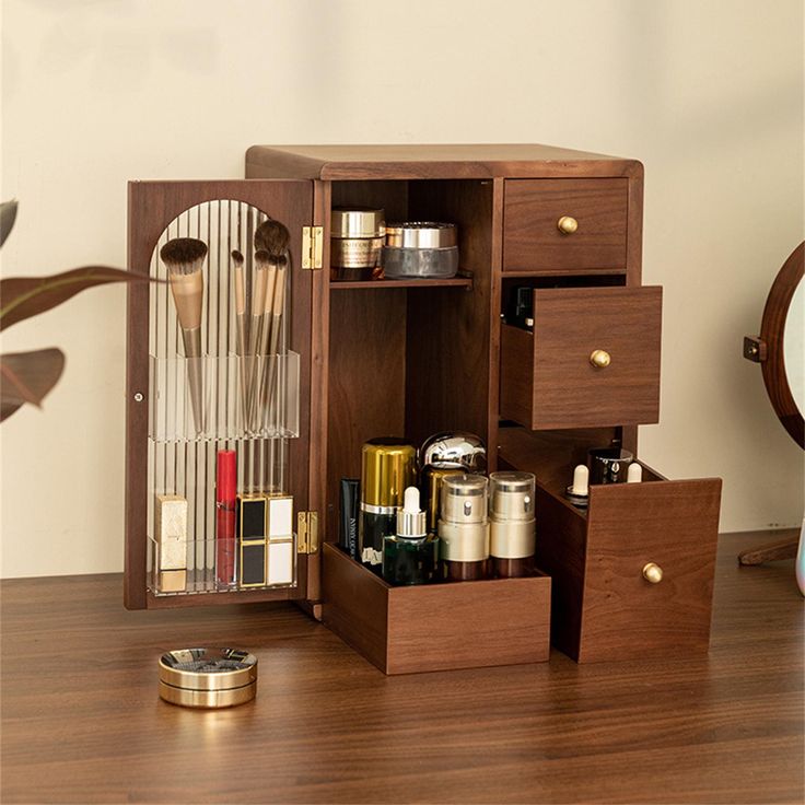 an open wooden cabinet with cosmetics and other items in it on top of a table