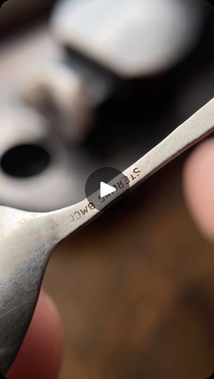 a close up of a person holding a pair of scissors in their left hand with the words below it