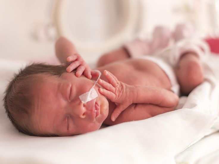 a baby is laying on its back with it's hands in the air