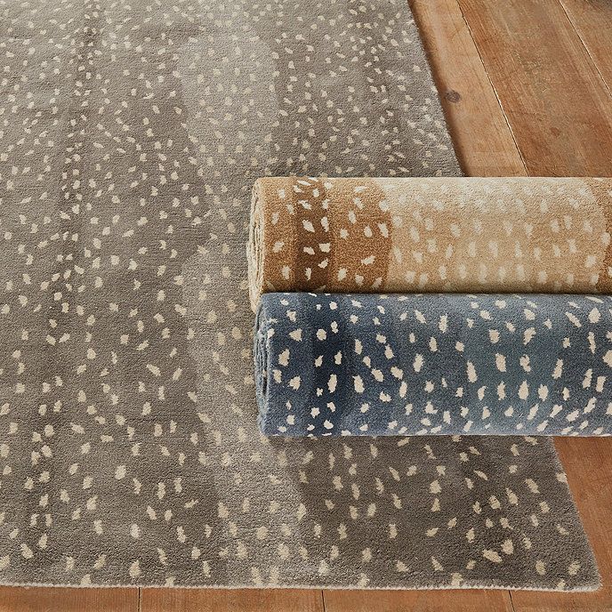 two rugs on the floor, one with white spots and one with brown spots