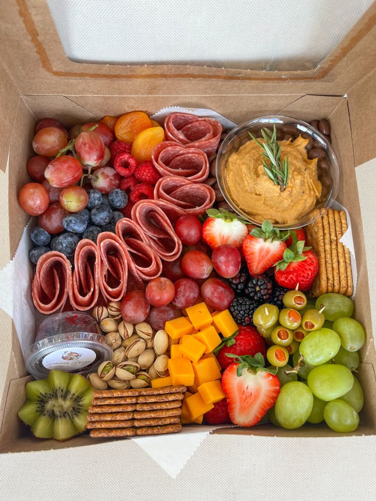 a box filled with assorted fruits and snacks