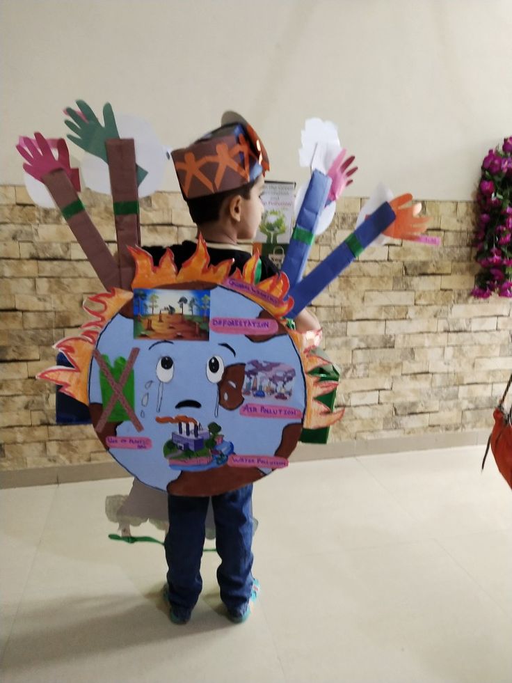 a young boy wearing a paper cut out costume