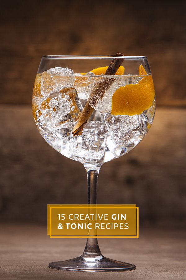 a gin and tonic cocktail with an orange garnish