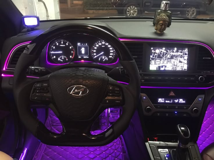 the interior of a car with purple lighting