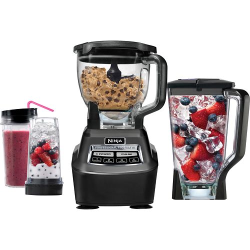 the blender is filled with different types of food and has strawberries in it