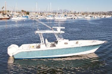 a white boat is in the water near many boats