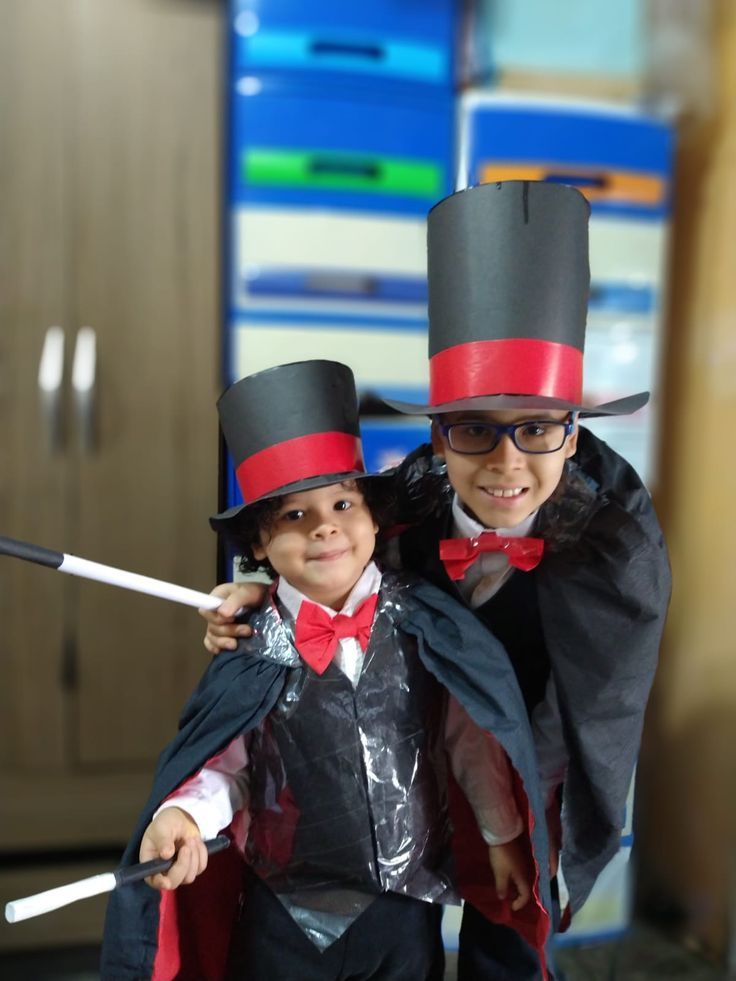 two children dressed up in costumes posing for the camera