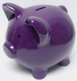 a purple piggy bank sitting on top of a white table