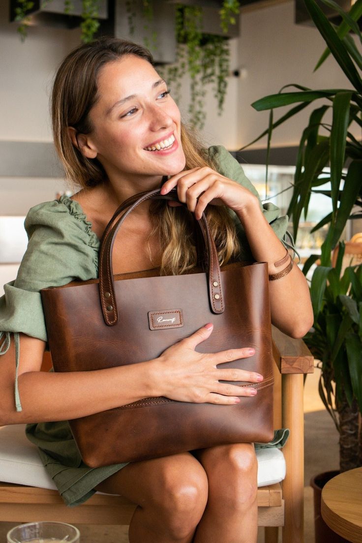 Whether you're in the office or on the go, this leather tote is the perfect everyday bag.  Its spacious main compartment can hold a 15" laptop and has two matching top handles for an easy use. Crafted from full grain calf leather, this Tote bag has the room and structure for all your day to day to day essentials. -Foil embossed Roarcraft logo on the front  -Two top leather handles -Main internal compartment -Internal pocket -Height: 28.5cm -Width: 35cm -Depth: 13cm -Weight: 700 gr A great option Luxury Recycled Leather Tote Shoulder Bag, Everyday Leather-lined Laptop Tote Bag, Everyday Laptop Bag With Leather Lining, Everyday Laptop Bag With Leather Lining And Tote Shape, Leather Briefcase With Removable Pouch For Everyday, Everyday Soft Leather Tote Briefcase, Everyday Soft Leather Shoulder Briefcase, Everyday Shoulder Briefcase With Smooth Grain, Everyday Leather Briefcase With Double Handle