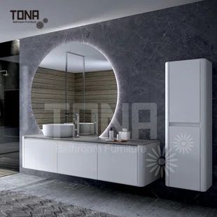 a modern bathroom with an oval mirror above the sink