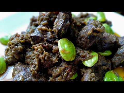 the food is prepared and ready to be eaten on the plate with green peppers around it