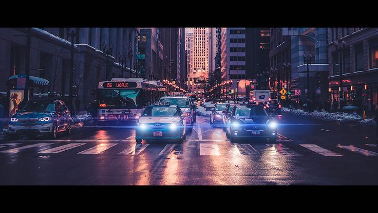 cars and buses on a city street at night