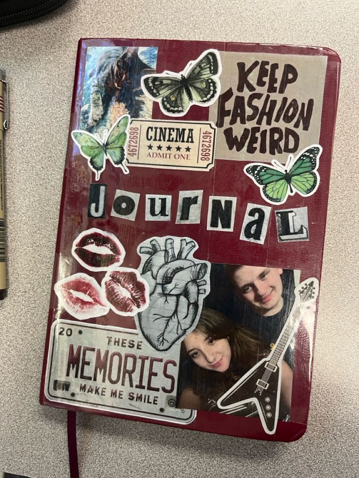 a red journal with stickers on it