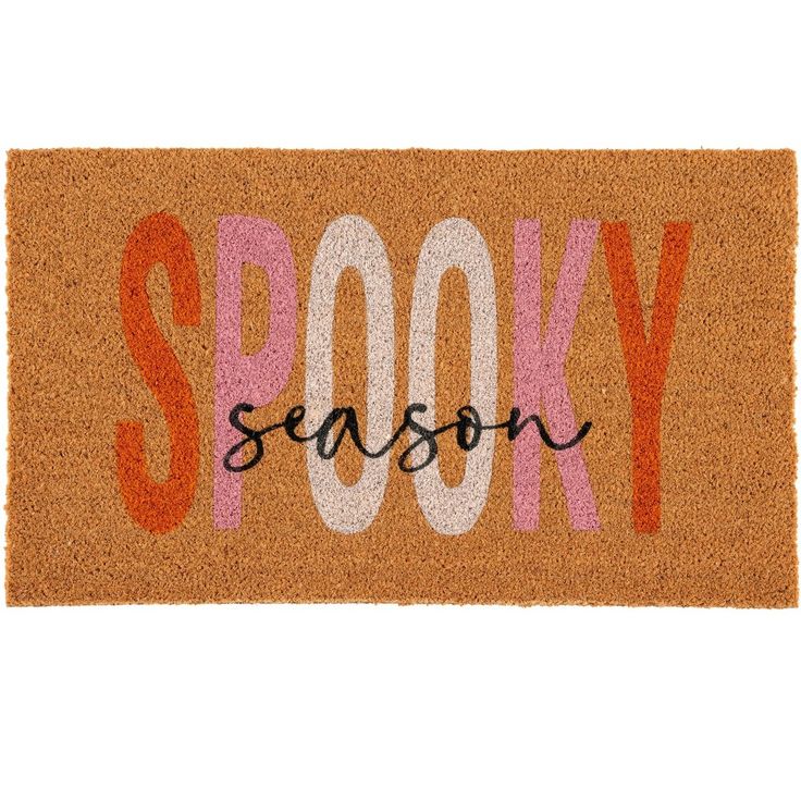 a door mat with the word spooky on it in white and orange letters