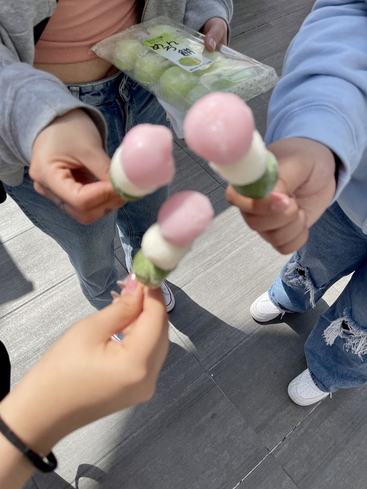 several people holding candy lollipops in their hands