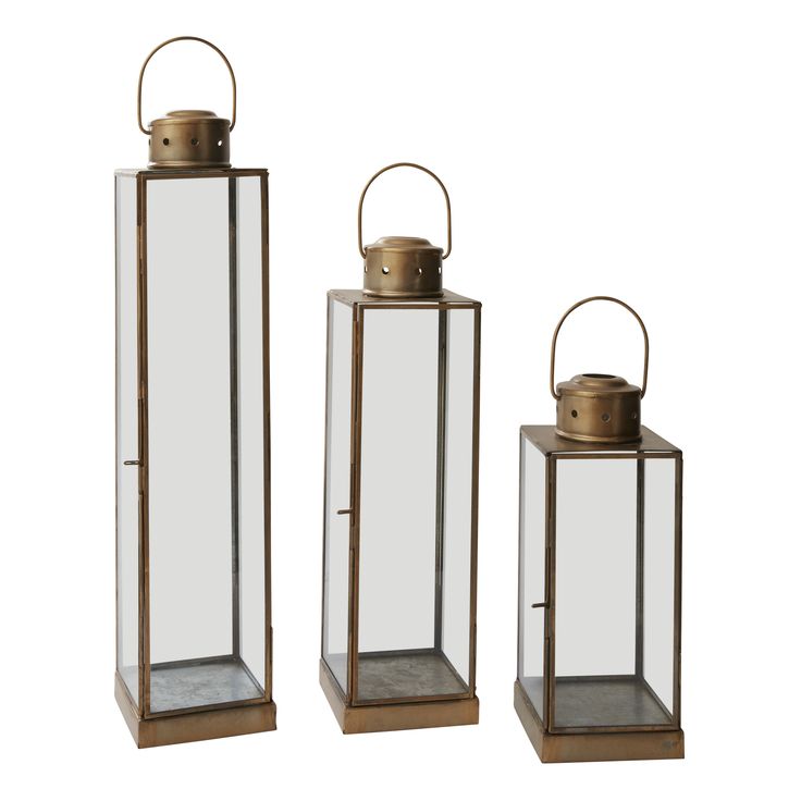 three metal and glass lanterns on white background