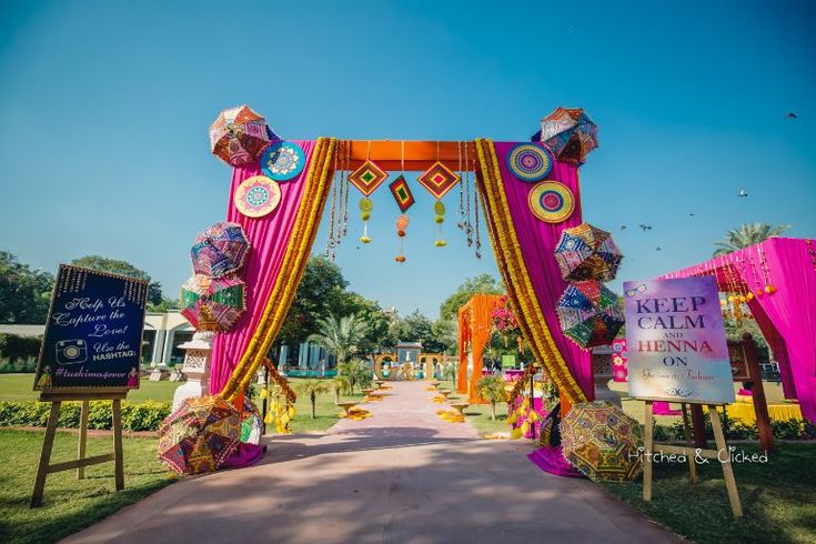 an outdoor ceremony with colorful decorations and signs