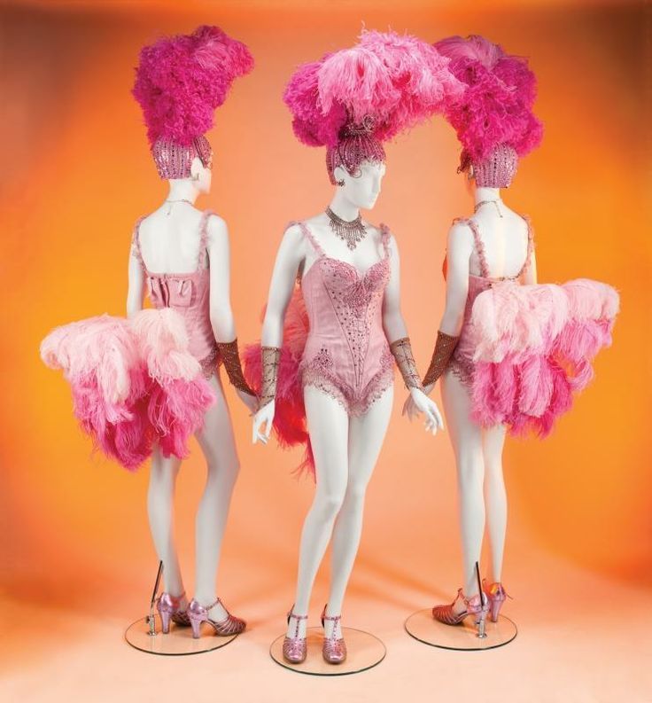 three mannequins dressed in pink and pink feathers