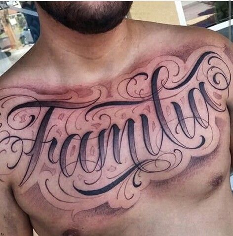 a man with a tattoo on his chest has the word family written in cursive writing