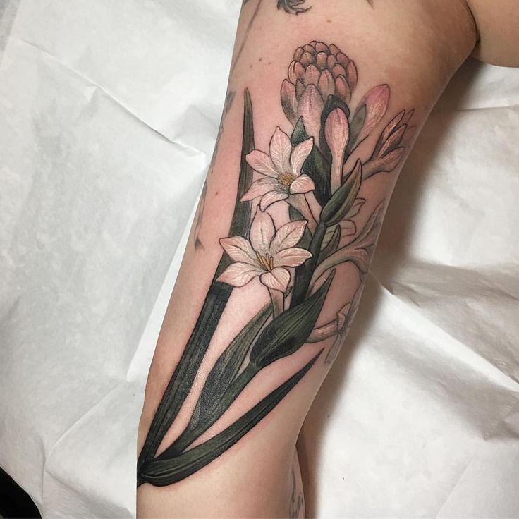 a woman's arm with flowers on it